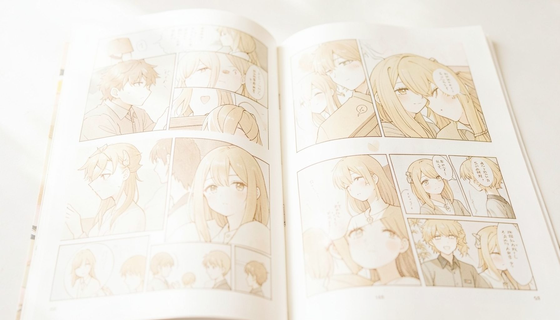 A bright, airy high-key photograph of a manga page spread with soft natural light falling across illustrated panels, cream and pale gold tones
