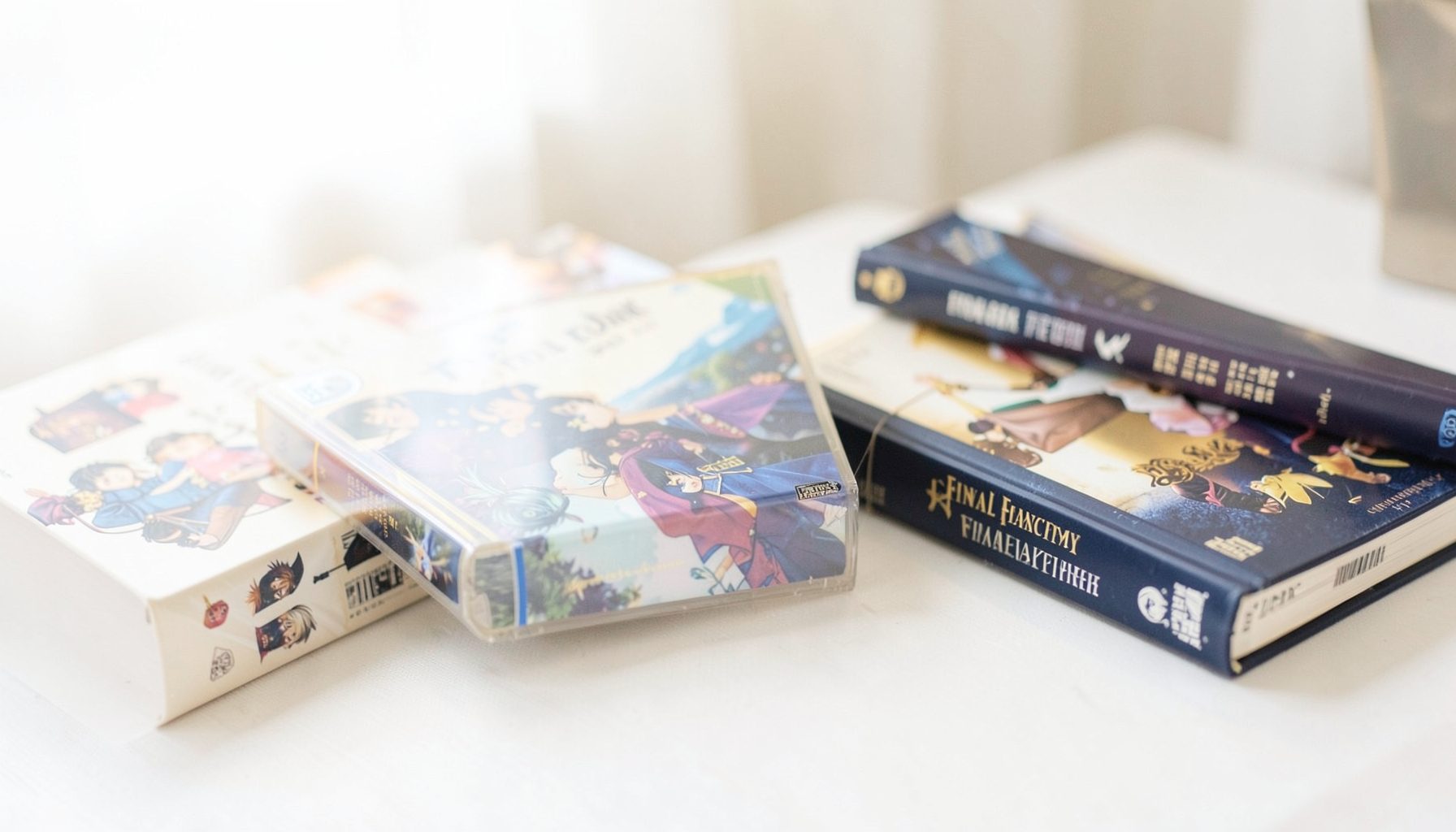 A bright, airy photograph of a Final Fantasy game case beside art books, soft gold and navy tones